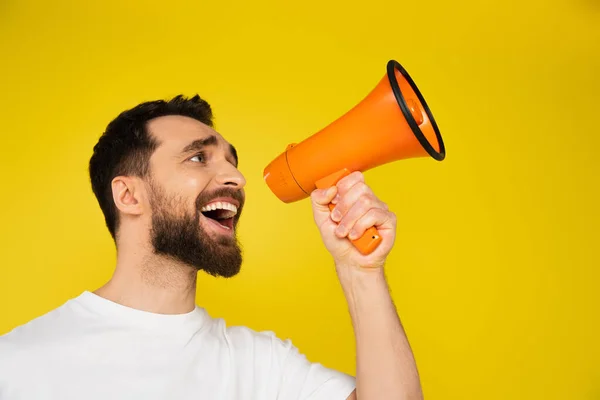 Brunette Bearded Man Shouting Megaphone While Looking Away Isolated Yellow — Stock Photo, Image