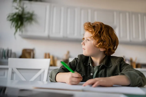 Thoughtful Redhead Boy Pen Doing Homework Looking Away — Stock Photo, Image
