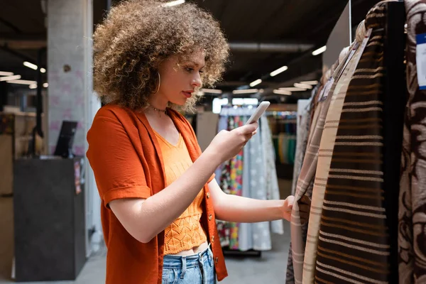 Curly Customer Taking Photo Cellphone While Choosing Fabric Textile Shop — Stock Photo, Image