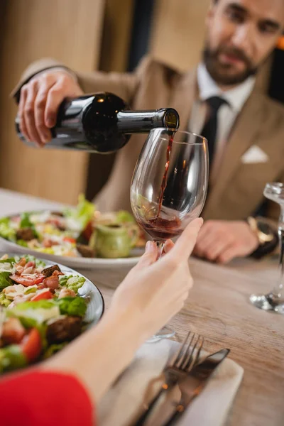 Blurred Man Pouring Red Wine Glass Woman Dinner Valentines Day — Stock Photo, Image