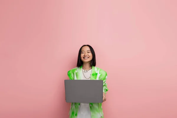 Cheerful Asian Woman Green White Jacket Smiling Laptop Isolated Pink —  Fotos de Stock