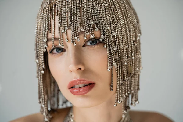 stock image Portrait of young woman in jewelry headwear posing isolated on grey 