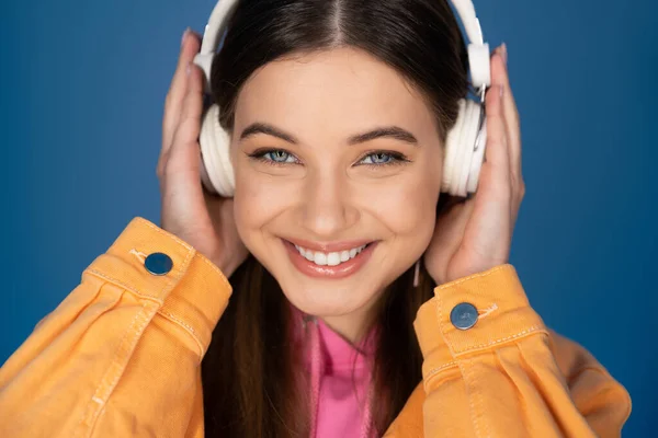 Portrait Cheerful Brunette Teenager Headphones Looking Camera Isolated Blue — Foto Stock
