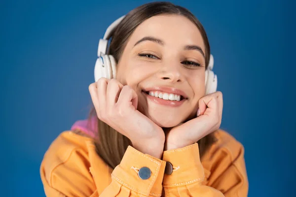 Portrait Cheerful Teenager Headphones Looking Camera Isolated Blue — Foto Stock