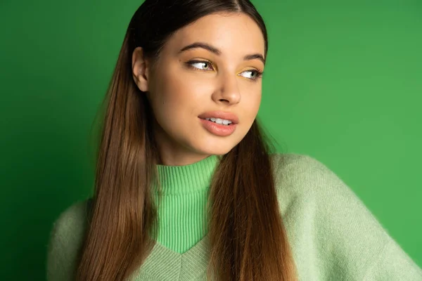 stock image Portrait of pretty teen girl in jumper standing on green background 