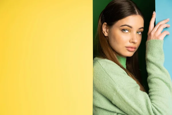 stock image Teenage girl in jumper looking at camera on colorful background 