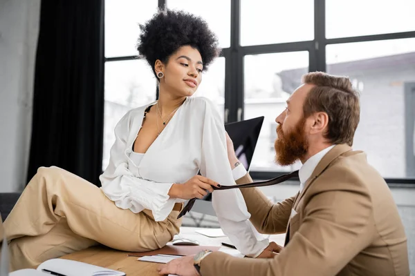 Cheerful African American Woman Sitting Desk Pulling Tie Bearded Coworker — 스톡 사진