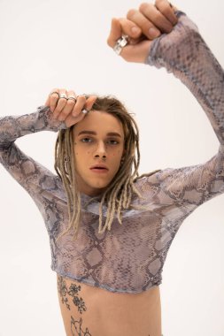 Tattooed queer person in stylish crop top with animal print isolated on white 
