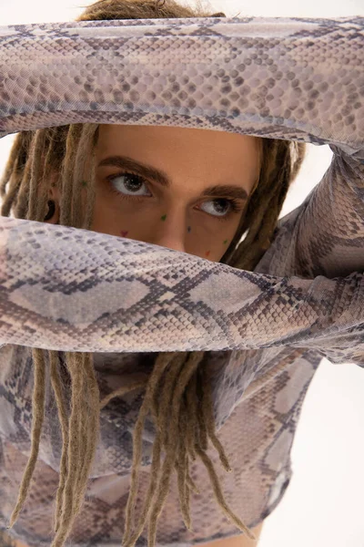 Portrait of tattooed queer person looking away isolated on white 