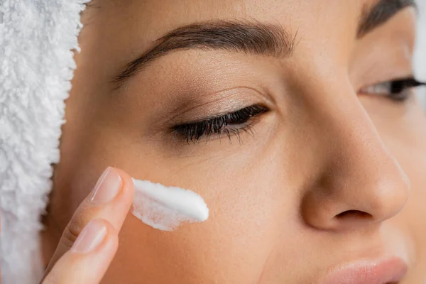 stock image Cropped view of woman applying face cream isolated on grey 