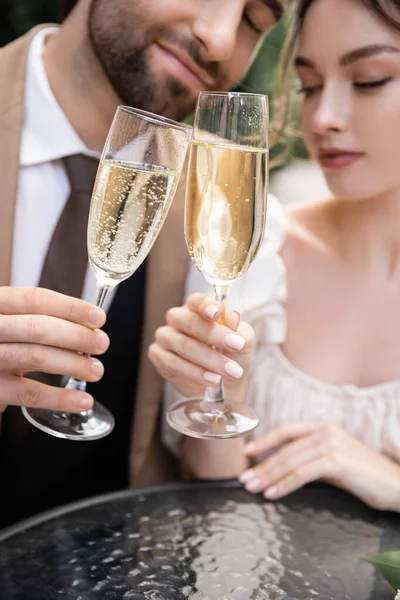 stock image young newlyweds clinking glasses of champagne during wedding celebration 