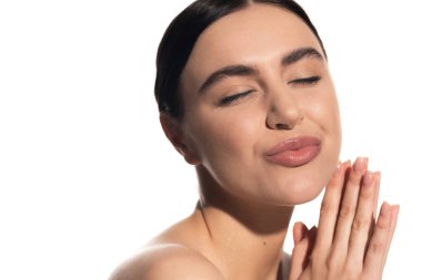 cheerful young woman with natural makeup and closed eyes pouting lips isolated on white