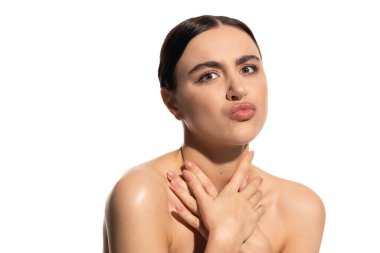 brunette woman with bare shoulders and natural flawless makeup pouting lips isolated on white 