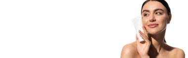 happy young woman with bare shoulders holding tube with body lotion isolated on white, banner 