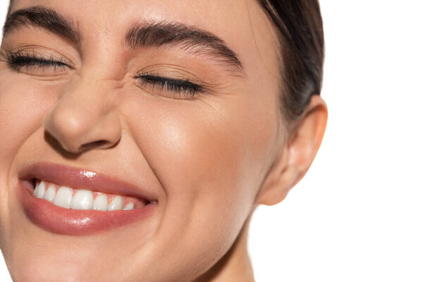 close up of happy young woman with flawless natural makeup smiling isolated on white 