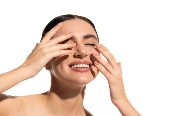 happy young woman with flawless makeup touching skin isolated on white 