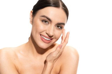 charming woman touching soft cheek and smiling isolated on white 