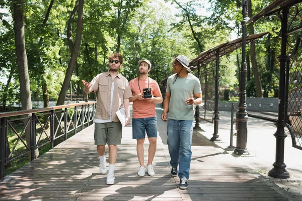 여름에는 문화를 여행하는 사람들 공원을 산책하면서 손으로 방향을 안내원 — 스톡 사진