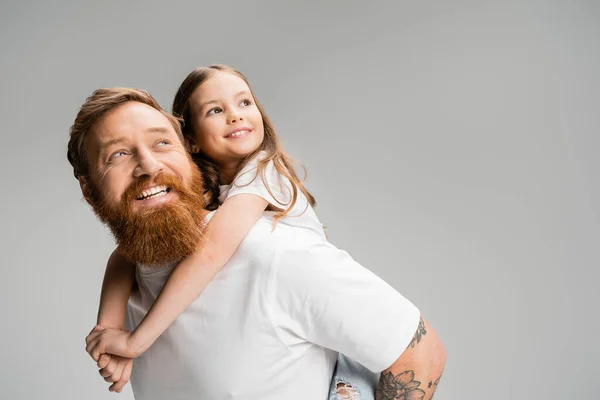 Cheerful Child Looking Away While Piggybacking Bearded Father Isolated Grey — Stock Photo, Image