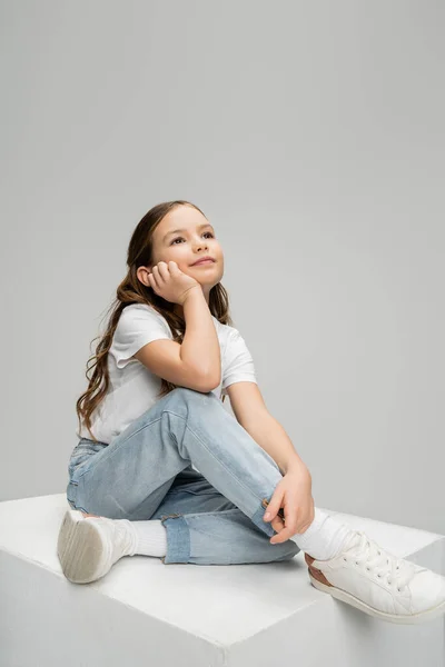 Dreamy Kid Casual Clothes Sitting White Cube Isolated Grey — Stock Photo, Image