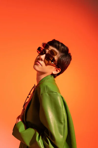 Stylish Brunette Woman Posing Several Sunglasses Green Leather Jacket Orange — Stock Photo, Image