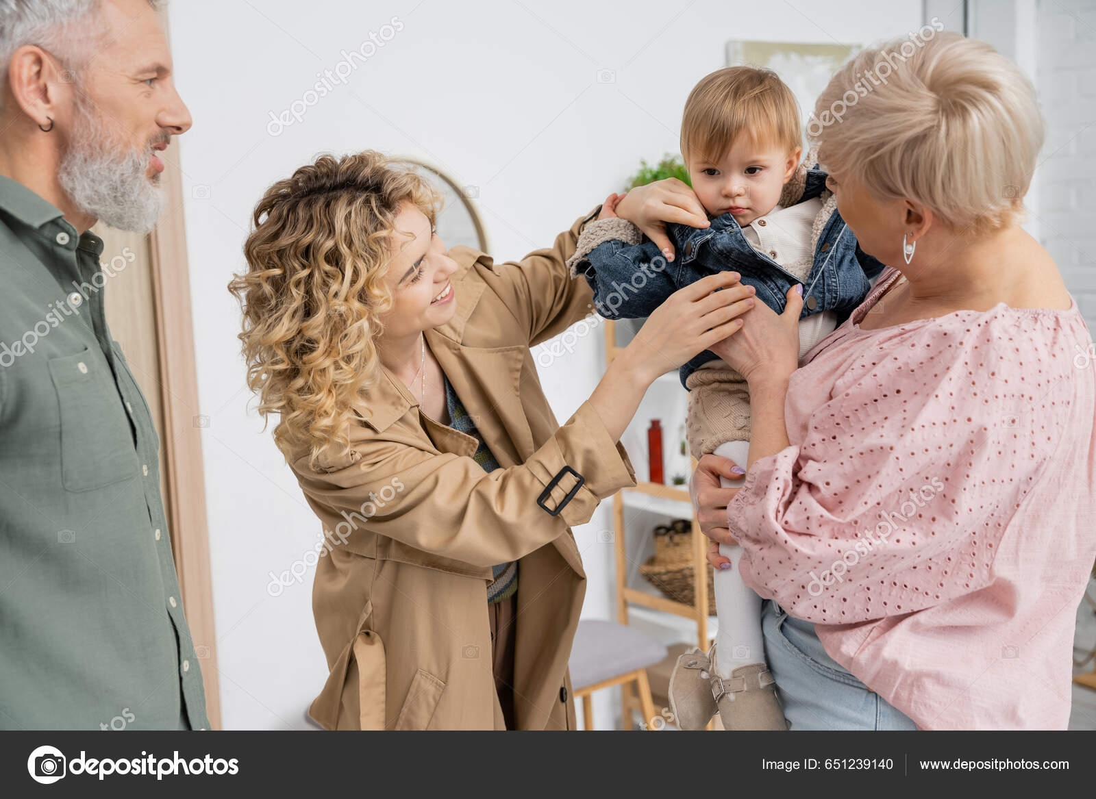 Smiling Blonde Woman Undressing Daughter While Visiting Grandparents Home  Stock Photo by ©AllaSerebrina 651239140