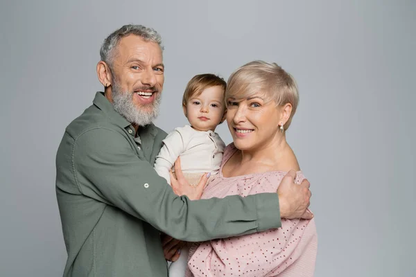 Overjoyed Grandparents Looking Camera Beloved Granddaughter Isolated Grey — Stock Photo, Image