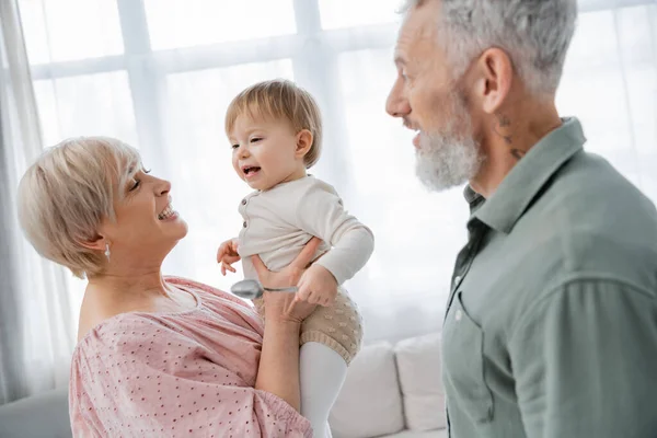 Happy Mature Woman Holding Beloved Granddaughter Bearded Husband Home — Stock Photo, Image