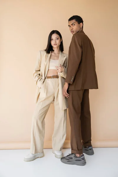Full Length Young Interracial Couple Trendy Pantsuits Looking Camera While — Stock Photo, Image