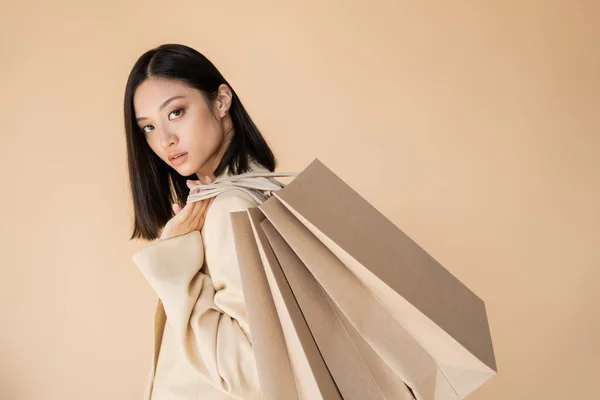 Sensual Asian Woman Ivory Blazer Holding Shopping Bags Looking Camera — Stock Photo, Image