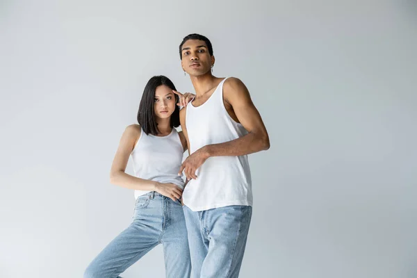 Slender Interracial Models Blue Jeans Tank Tops Looking Camera Isolated — Stock Photo, Image