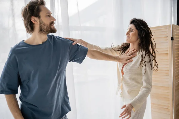Aggressive couple fighting during crisis in relationship at home