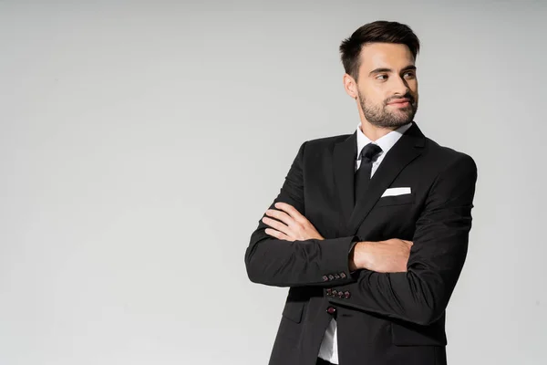 Χαμογελαστός Επιχειρηματίας Μαύρο Κοστούμι Στέκεται Διπλωμένα Χέρια Και Κοιτάζει Μακριά — Φωτογραφία Αρχείου