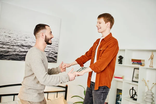 Excited Gay Couple Holding Hands While Having Fun Bedroom Home — Stock Photo, Image