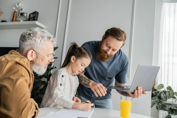 Gay Father Holding Laptop Daughter Writing Notebook Partner Home — Stock Photo, Image