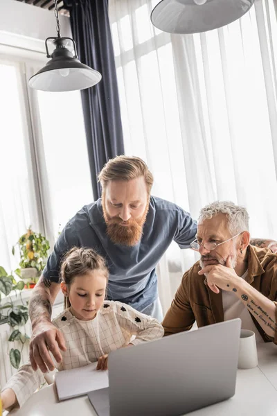 Gay Dads Using Laptop While Daughter Doing Homework Home — Stock Photo, Image