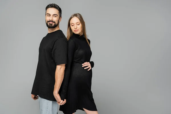 Positive Bearded Man Holding Hand Stylish Pregnant Wife Black Dress — Stock Photo, Image
