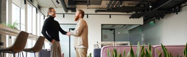 side view of entrepreneur in stylish casual clothes shaking hands with bearded and tattooed business partner and closing deal in contemporary coworking office with high tech interior, banner clipart