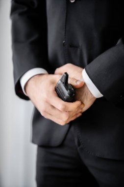 surveillance, cropped view of bodyguard standing with walkie talkie, man in black suit, hotel safety, security management, uniformed guard on duty, professional headshots  clipart