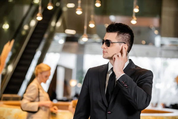 Bodyguard Sunglasses Handsome Man Suit Tie Touching Earpiece Lobby Hotel — Stock Photo, Image