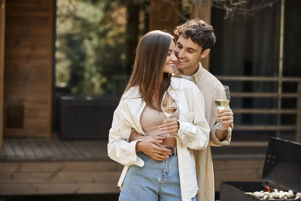 Smiling Man Hugging Girlfriend Holding Wine Bbq Blurred Vacation House — Stock Photo, Image