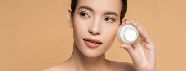 Young Brunette Asian Modern Perfect Skin Holding Cosmetic Cream Isolated — Stock Photo, Image