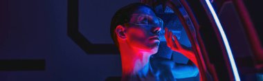 futuristic concept, humanoid alien in goggles inside innovative device in scientific lab, banner clipart