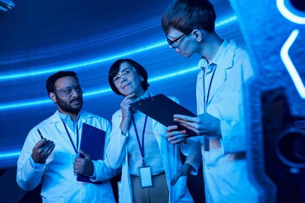 stock image innovation hub, multiethnic scientists working on invention in futuristic science center