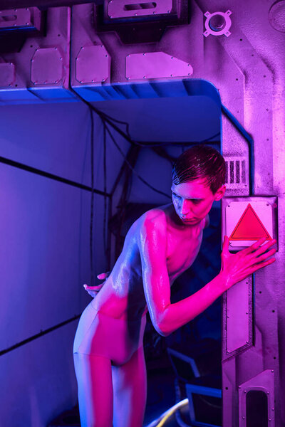 cosmic phenomenon, unknown humanoid alien, space traveler in neon light of futuristic science center