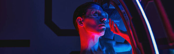 futuristic concept, humanoid alien in goggles inside innovative device in scientific lab, banner
