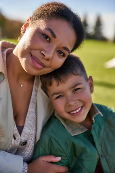 stock image portrait of happy african american woman and boy, mother and son hugging, love and bonding