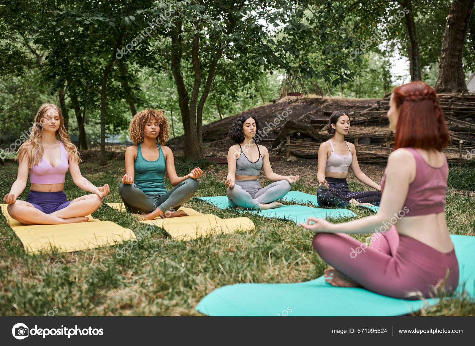 Multiethnic Women Yoga Mats Meditating Lotus Pose Coach Park Stock