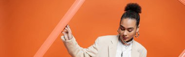 Ekmek ve aksesuarları turuncu çerçeveli şık giyimli zarif bir manken.