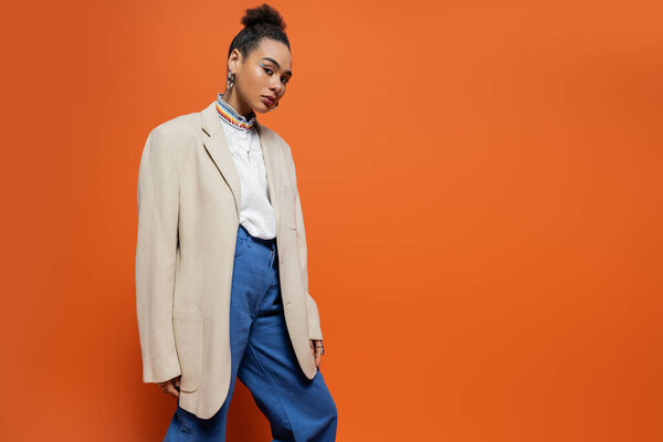 stylish fashion model with vivid colourful makeup and accessories posing and looking at camera